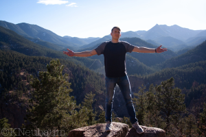 Portrait Photography Portfolio Example of a person hiking in the colorado mountains with arms stretched out, looking out at the view